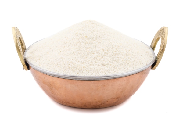 raw unprepared semolina flour or suji on white background - Морковные постные котлеты