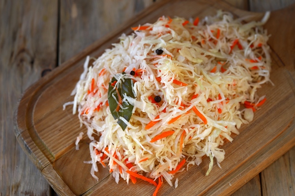 sauerkraut on a wooden board fermented foods probiotics - Зимняя каша из квашеной капусты