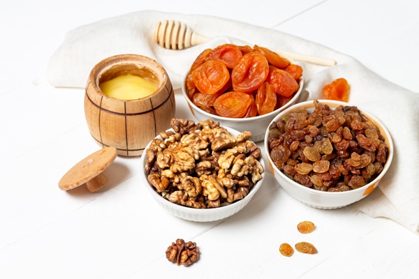 set of dried berries fruits and nuts lying in a plate walnuts pumpkin cherry apricot apple dates - Коврижка постная