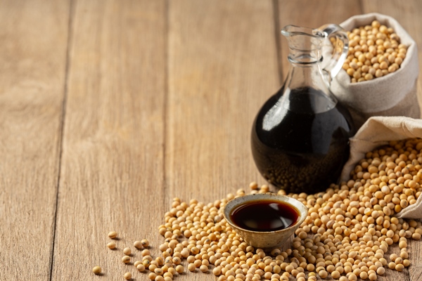 soybean sauce and soybean on wooden floor soy sauce food nutrition concept - Кисло-сладкий постный соус
