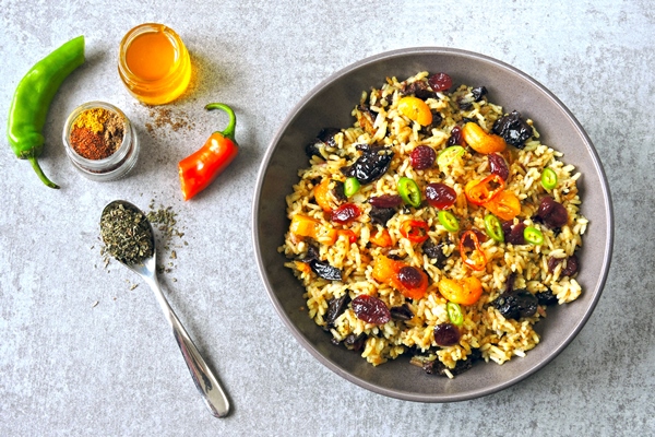 spicy rice with dried fruits vegan bowl with spicy rice healthy lunch - Постный плов с черносливом