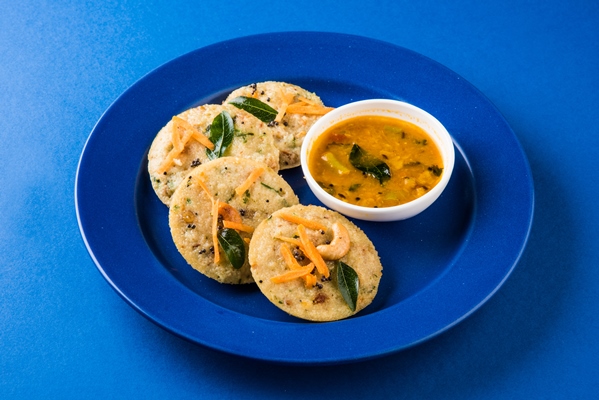steam cooked semolina cakes known as rava idli or idly served with sambar and coconut chutney selective focus - Манные котлеты