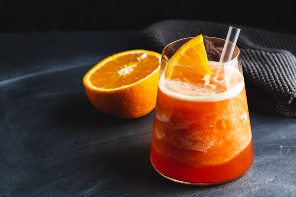 tasty sweet freshmade refreshing summer cocktail with oranges and mint served in glass closeup - Апельсиновый маседуан