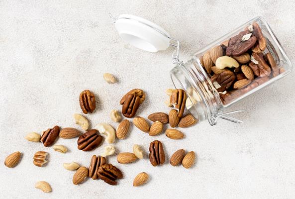top view of transparent jar with assortment of nuts - Каша геркулесовая