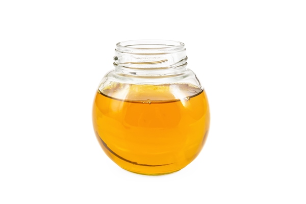 vegetable oil in glass jar isolated on white background - Постный именинный крендель