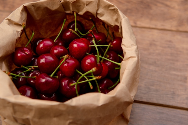 cherries in craft paper package on wooden table - Вишнёвый квас