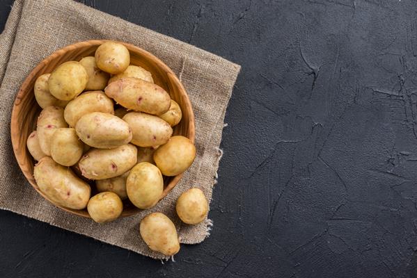 copy space organic potatoes on table - Драники с зеленью и луком