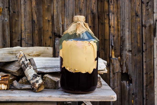 craft alcohol birch tincture in a large glass bottle on a wooden table russian folk recipe - Ларисин квас