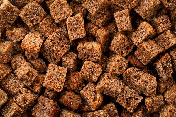 croutons brown background close up texture from small pieces of dried bread top view - Донецкий квас