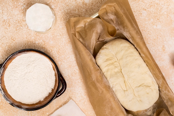 flour egg kneaded dough on beige textured backdrop - Домашний хлеб на сухих дрожжах