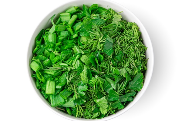 fresh chopped greens in a bowl are isolated on a white background top view - Ботвинья с рыбой