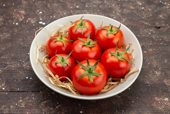 front close view fresh red tomatoes inside white plate on the wooden brown background vegetable fruit color - Постный суп из чечевицы с баклажанами