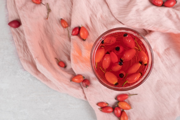 glass of fresh lemonade with rosehips on cloth - Суп яблочный на отваре шиповника