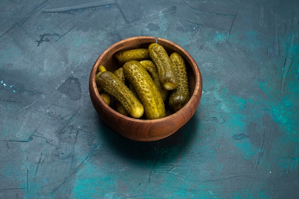 half top view salty pickles inside round brown pot on dark blue desk - Грибная окрошка, постный стол