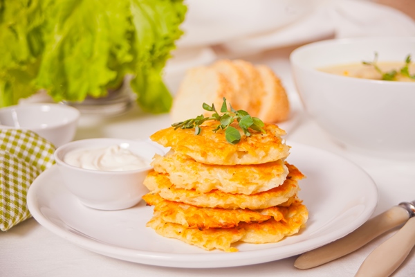 hash browns potato pancakes draniki on the white plate breakfast 1 - Драники с кабачками и луком