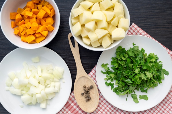 ingredients for soup top view of carrot onion potato cilantro pepper - Щи из свежей капусты постные