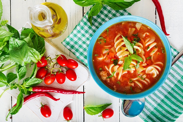 minestrone italian vegetable soup with pasta tomatoes soup vegan food top view flat lay - Суп овощной с макаронами