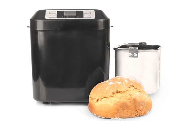 modern bread machine and fresh crusty loaf on white background - Гречнево-ржаной хлеб