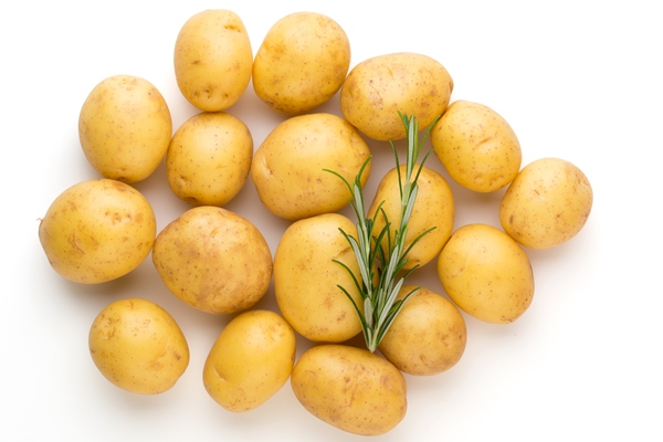 new potato and rosemary isolated on white table - Драники с пряностями