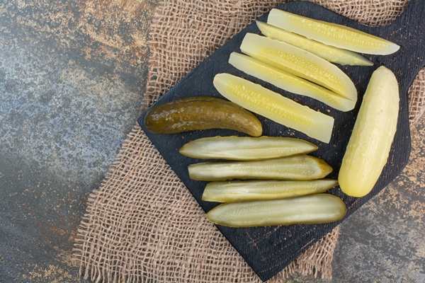 salty delicious cucumbers on dark board high quality photo - Свекольник постный