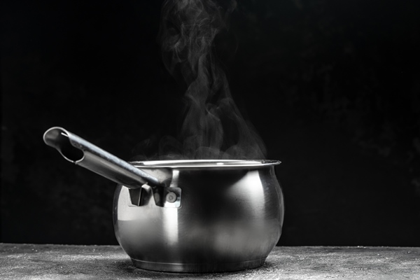 steaming pot on black background hot food concept bowl of hot steam of hot soup with smoke - Квас-сырец (украинская кухня)