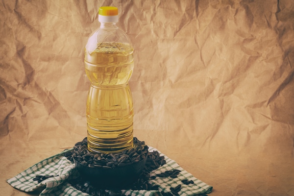 sunflower oil with a bag of seeds and a wooden spoon 1 - Драники с морковью и луком