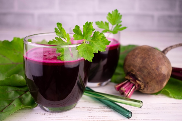 two glasses with healthy beetroot juice on a white wooden background close up - Квас бурачный (рецепт времен Киевской Руси)