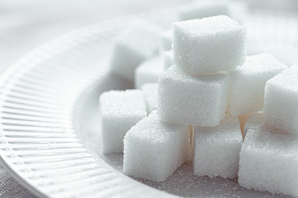 white refined sugar on a white porcelain plate selective focus front view macro close up - Квас из ягод черёмухи