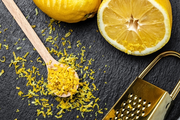 yellow organic lemons zest and special tool grater peel and lemon zest on black background banner menu recipe place for text top view - Оренбургский квас