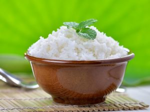 cooked white rice garnished with mint in a ceramic bowl - Постная рыбная кулебяка