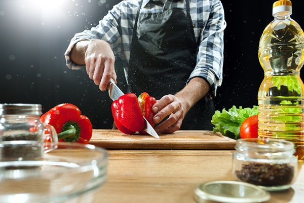 female chef cutting fresh vegetables - Постная аджика с овощами
