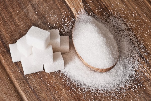 granulated sugar in wooden spoon and sugar cubes stacked in pyramid on wooden background - Печенье на рассоле с семечками
