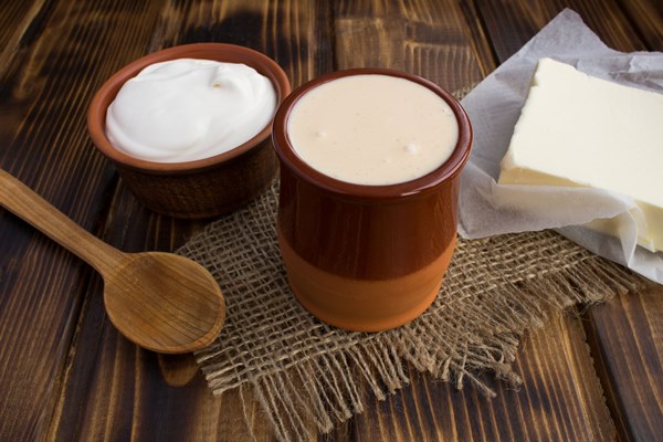 homemade ryazhenka sour cream and butter on the rustic background - Молодой картофель отварной