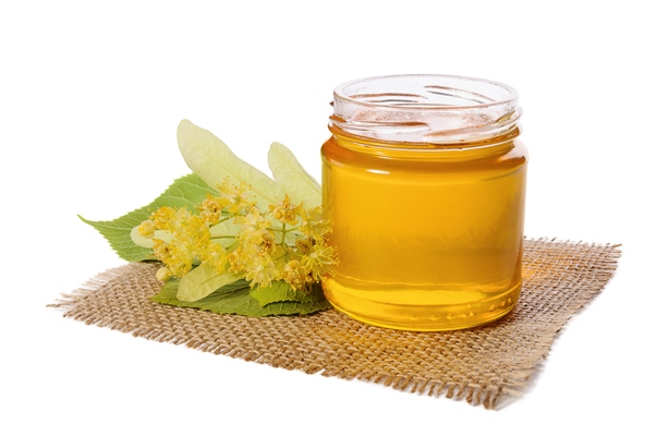 jar of linden honey and flowering linden on white - Сбитень с липовым цветом