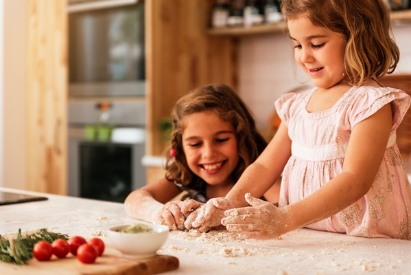 little sisters kneading dough preparing for baking cookies infant chef concept - Как научить ребенка готовить?