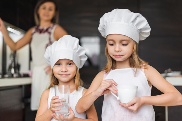 portrait of little girls wearing chef hat holding glass and cup - Пирожное "Картошка"