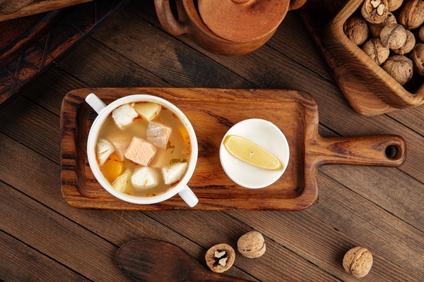 ukha fish soup with lemon on the wooden table 1 - Праздничная солянка по-монастырски