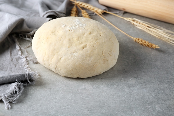 ball of raw dough on grey table - Сушки к чаю