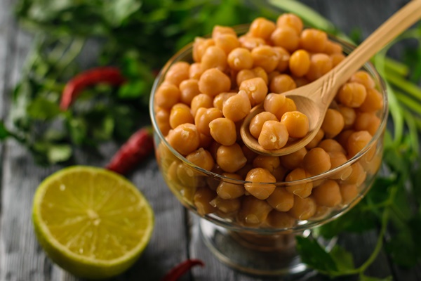 boiled chickpeas in a glass bowl pepper and lime on a table vegetarian cuisine from legumes - Фалафель, постный стол