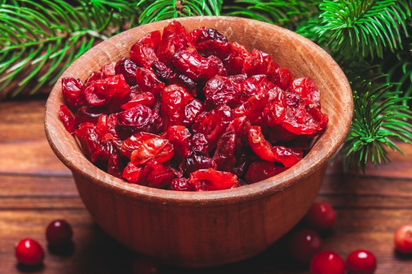 dried cranberries in a wooden bowl and fir branches - Тыква, запечённая с киноа, постный стол