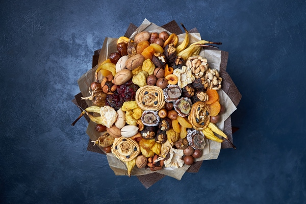 healthy bouquet of dried fruits and nuts top view on dark blue - Основы сухоядения