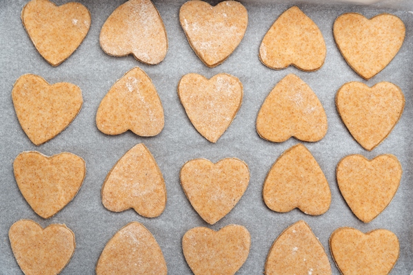 heart shaped shortbread cookies on parchment paper whole grain baked goods top view - Постные прянички из битого теста