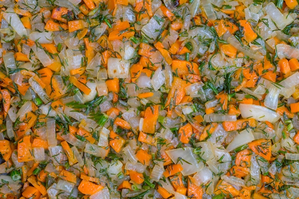 onions carrots and dill are finely chopped and fried in oil in a frying pan - Морковный суп с зелёным соусом