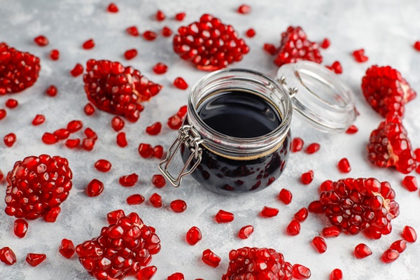 sweet pomegranate sauce or syrup for meat and fish called narsharab in a glass jar with purified pomegranate selective focus - Гранатовый напиток