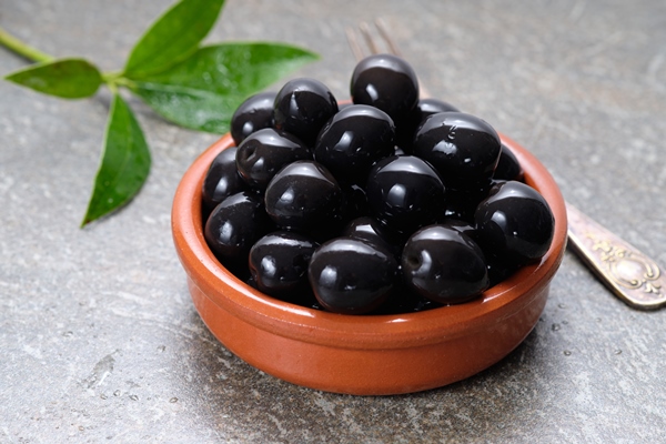 tasty black olives in the bowl on gray stone table - Новогодний бутерброд "Снеговик"