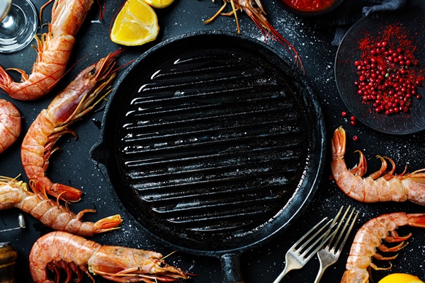 uncooked giant shrimps on dark table - Салат из рукколы и креветок