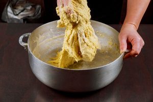 woman mixing with hand yeast dough for buns 1 - Песочный пирог с яблоком
