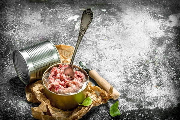 canned meat in a tin can on a rustic background - Суп с мясными консервами