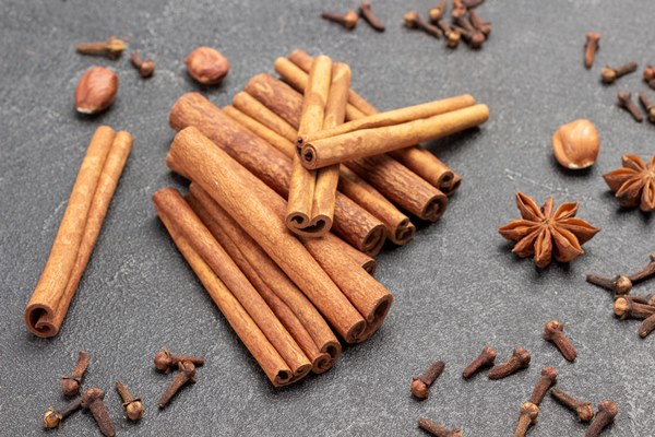 cinnamon sticks star anise cloves and nuts traditional christmas spices flat lay black background - Безалкогольный глинтвейн из гибискуса