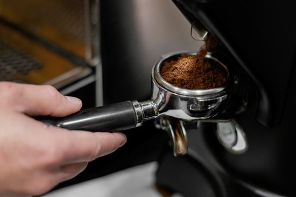 close up of male barista using professional coffee machine - Торре